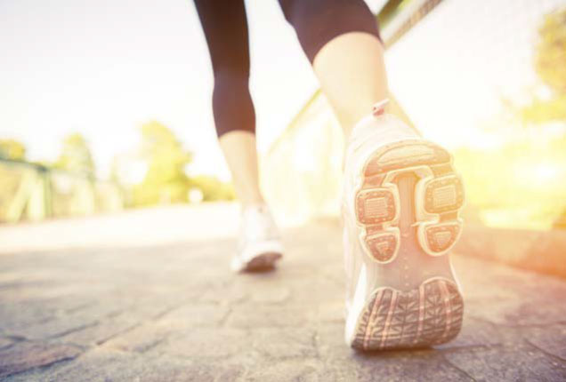 Close up of feet with walking shoes on a trail