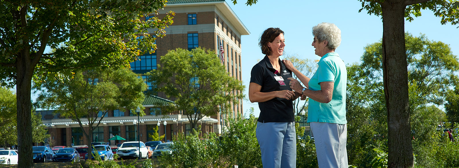 Patient speaking with occupational therapist outside CRH