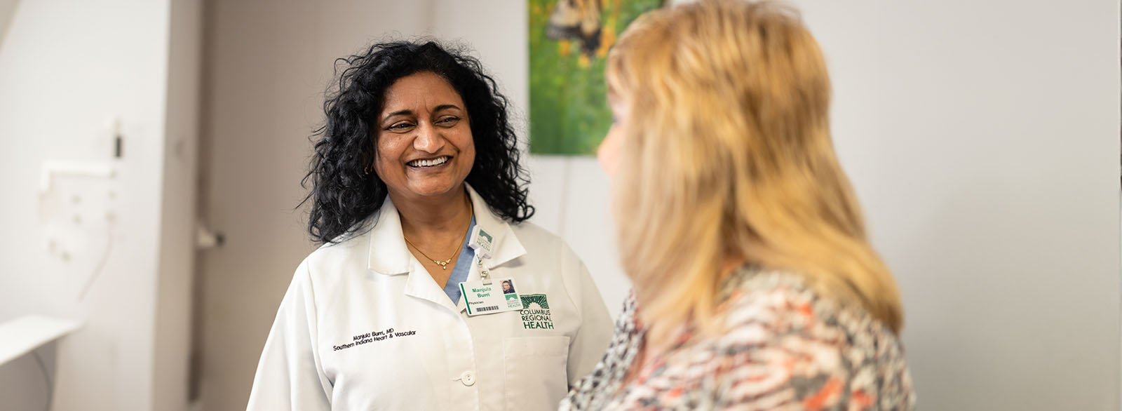 Dr. Manjula Burri visits with a patient.