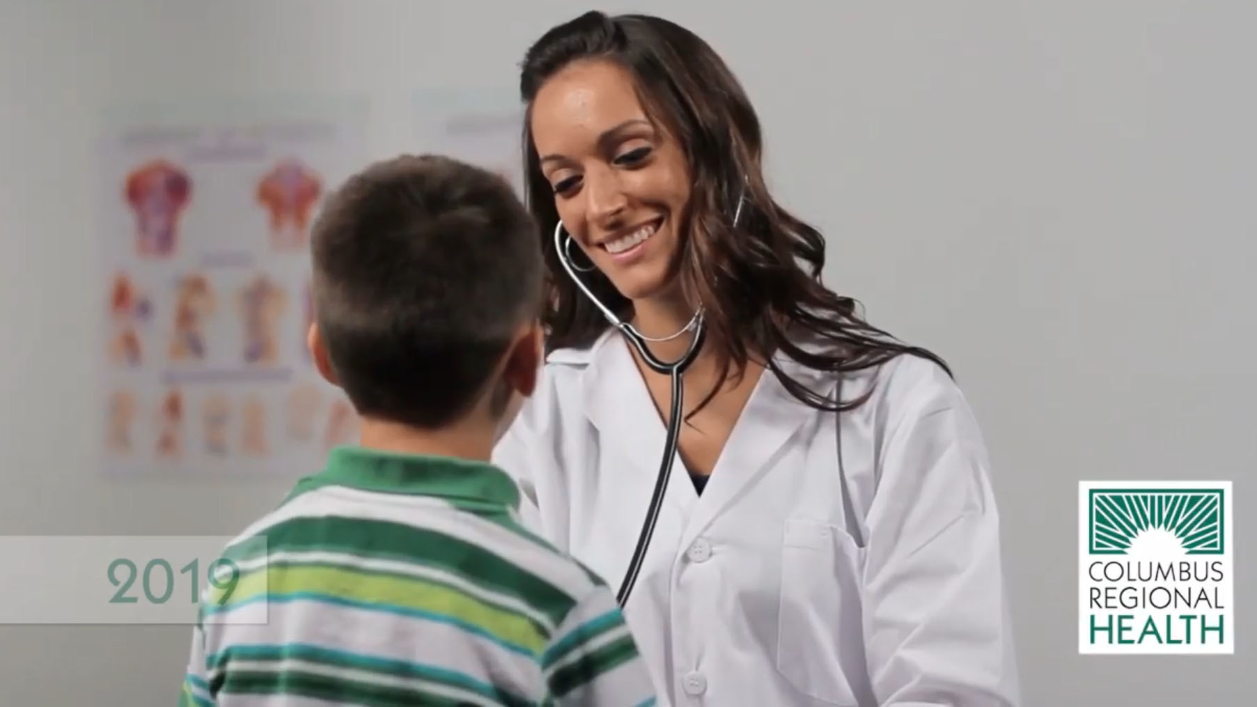 Nurse examining pediatric patient.