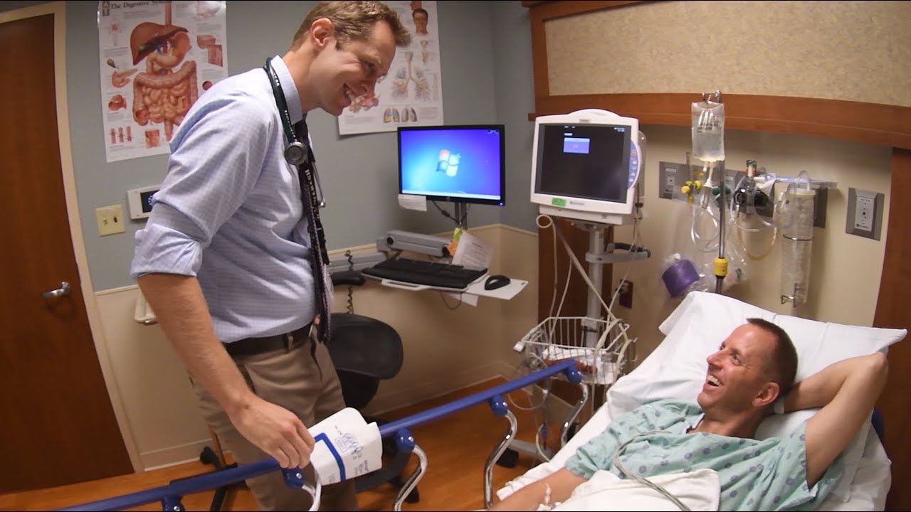 Gastroenterologist Patrick Barrett, MD, talks to patient Brad Davis before performing his colonoscopy.