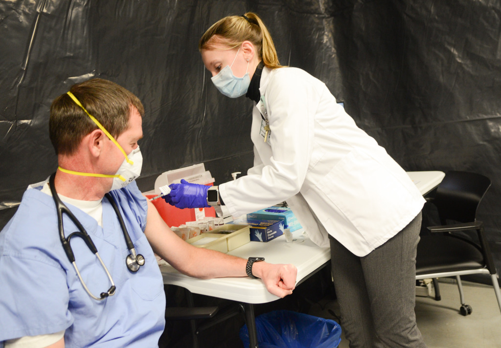 Dr. Lee Kiser receives the first dose of the COVID-19 vaccine.