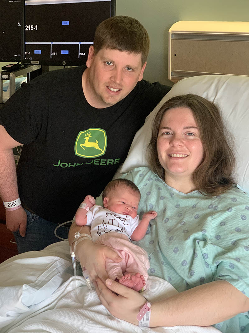 Father and mother with their newborn child at the Birthing Center at Columbus Regional Health.