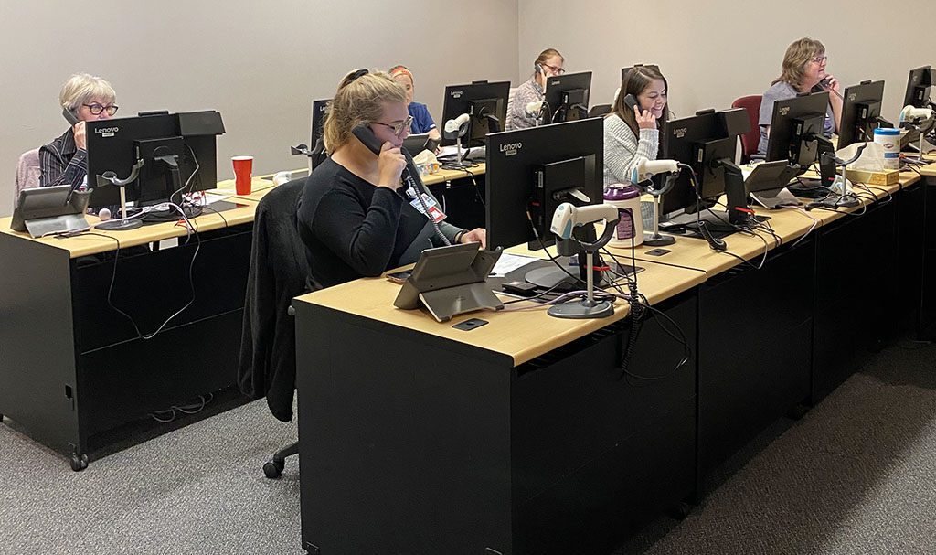 covid-19-triage-resource-call-center Nurses talking on telephones in a COVID-19 Triage Resource Call Center.