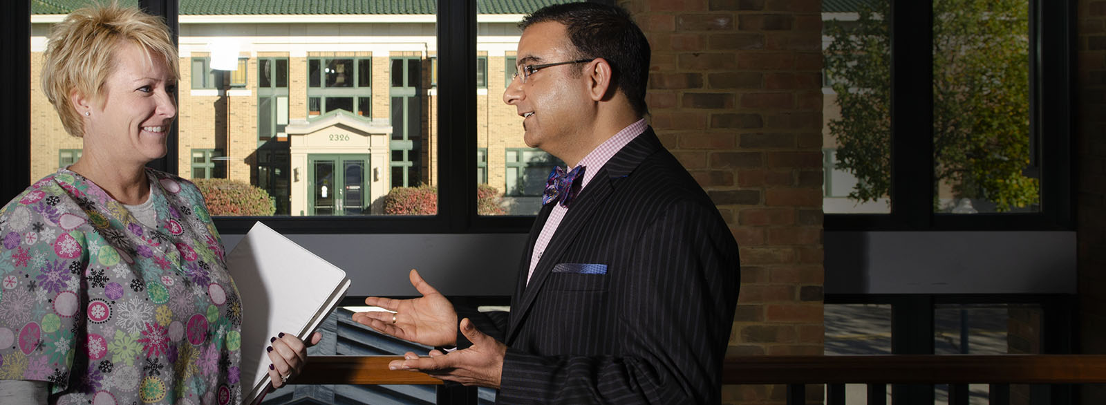 Dr. Jasuja speaks with a nurse